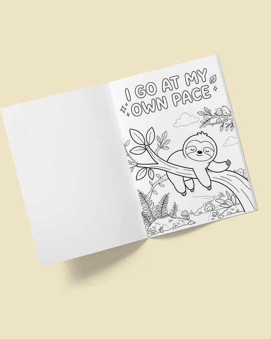 Open Animal Kingdom colouring book with a blank page beside an I go at my own pace colouring page of a sleeping sloth