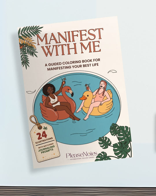 Manifest With Me guided colouring and journaling workbook cover showing two women relaxing on a flamingo and a duck pool float, with a tag reading 24 illustrations with matching journaling prompts